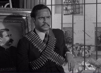 Movie still from “Viva Zapata!” (1952), directed by Elia Kazan – A black and white photo of a man in a suit and tie; Medium shot, Low angle