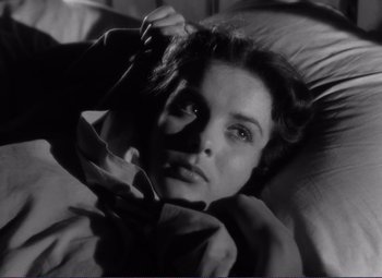 Movie still from “Viva Zapata!” (1952), directed by Elia Kazan – A black and white photo of a woman laying in a bed; Close Up shot, Low angle