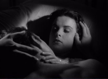 Movie still from “Viva Zapata!” (1952), directed by Elia Kazan – A woman laying in a bed with her hand on her head; Close Up shot, High angle