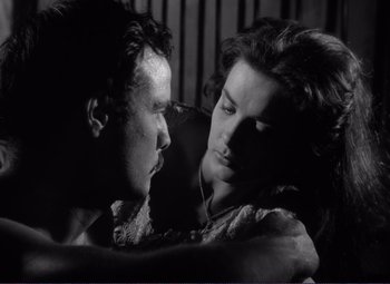 Movie still from “Viva Zapata!” (1952), directed by Elia Kazan – A man and a woman embracing each other in a black and white photo; Close Up shot, Low angle