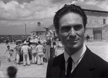 Movie still from “Viva Zapata!” (1952), directed by Elia Kazan – A black and white photo of a man in a suit and tie; Close Up shot, Low angle