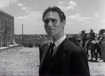 Movie still from “Viva Zapata!” (1952), directed by Elia Kazan – Black and white photograph of a man wearing a suit and tie; Medium shot, Low angle