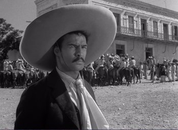 Movie still from “Viva Zapata!” (1952), directed by Elia Kazan – A black and white photo of a man wearing a cowboy hat; Medium shot, Low angle