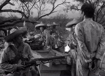 Movie still from “Viva Zapata!” (1952), directed by Elia Kazan – A black and white photo of a group of men with guns; Wide shot, Low angle