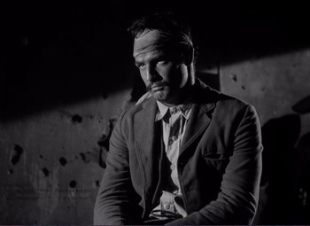 Movie still from “Viva Zapata!” (1952), directed by Elia Kazan – A black and white photo of a man in a suit and tie; Medium shot, Low angle