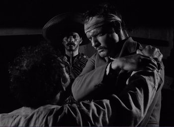 Movie still from “Viva Zapata!” (1952), directed by Elia Kazan – A man in a bandanna standing next to another man in a bandanna; Close Up shot, Over the shoulder angle