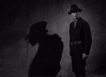 Movie still from “Viva Zapata!” (1952), directed by Elia Kazan – A black and white photo of a man in a hat and a suit; Medium shot, Low angle