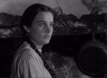 Movie still from “Viva Zapata!” (1952), directed by Elia Kazan – A young woman with long dark hair wearing a white shirt; Close Up shot, Over the shoulder angle