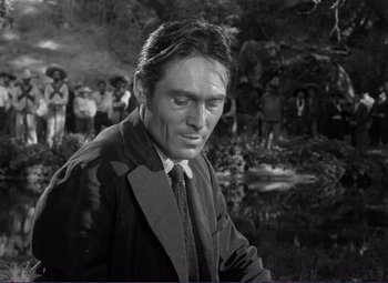 Movie still from “Viva Zapata!” (1952), directed by Elia Kazan – Black and white photograph of a man in a suit and tie; Close Up shot, Over the shoulder angle