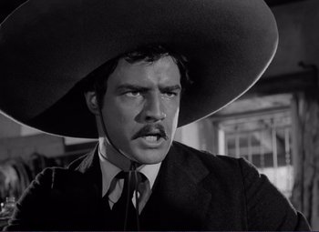 Movie still from “Viva Zapata!” (1952), directed by Elia Kazan – A black and white photo of a man with a mustache wearing a hat; Close Up shot, Low angle