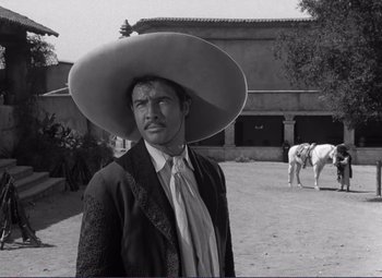 Movie still from “Viva Zapata!” (1952), directed by Elia Kazan – A black and white photo of a man wearing a sombrero; Medium shot, Low angle