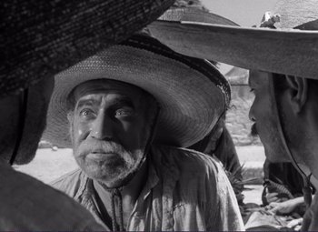 Movie still from “Viva Zapata!” (1952), directed by Elia Kazan – An old man wearing a straw hat and looking at the camera; Close Up shot, Over the shoulder angle