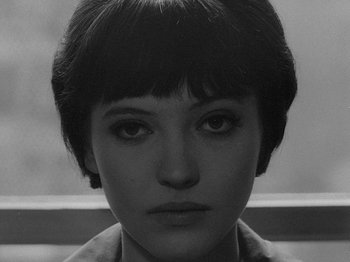 Movie still from “My Life to Live” (1962), directed by Jean-Luc Godard – A black and white photo of a woman with short hair; Close Up shot, High angle