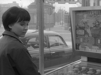 Movie still from “My Life to Live” (1962), directed by Jean-Luc Godard – A young woman looking at a display window; Medium shot, Over the shoulder angle