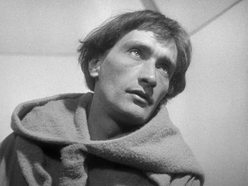 Movie still from “My Life to Live” (1962), directed by Jean-Luc Godard – A black - and - white photo of a man in a robe looking up; Close Up shot, Low angle