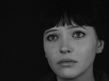 Movie still from “My Life to Live” (1962), directed by Jean-Luc Godard – A person with a tear in her eye; Close Up shot, High angle