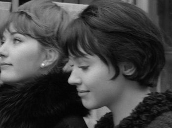 Movie still from “My Life to Live” (1962), directed by Jean-Luc Godard – Two young women sitting next to each other on a bus; Close Up shot, Low angle