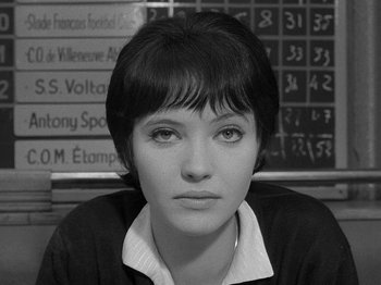 Movie still from “My Life to Live” (1962), directed by Jean-Luc Godard – Black and white photograph of a young woman in front of numbers; Close Up shot, High angle
