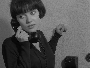 Movie still from “My Life to Live” (1962), directed by Jean-Luc Godard – A black and white photo of a woman holding a phone to her ear; Close Up shot, High angle