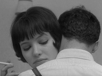 Movie still from “My Life to Live” (1962), directed by Jean-Luc Godard – A man and a woman are hugging each other; Close Up shot, High angle