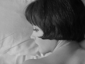 Movie still from “My Life to Live” (1962), directed by Jean-Luc Godard – A black - and - white photo of a woman's face; Close Up shot, Overhead angle