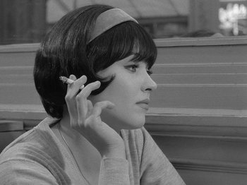 Movie still from “My Life to Live” (1962), directed by Jean-Luc Godard – A young woman is talking on a cell phone; Close Up shot, High angle