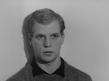 Movie still from “My Life to Live” (1962), directed by Jean-Luc Godard – Black and white photograph of a young man in a sweater; Close Up shot, Low angle