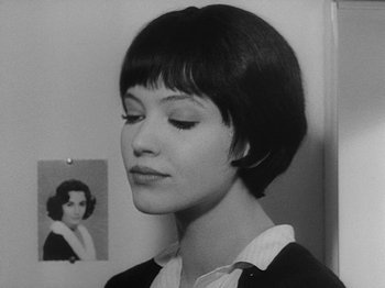Movie still from “My Life to Live” (1962), directed by Jean-Luc Godard – A black - and - white photo of a woman with short hair; Close Up shot, Over the shoulder angle