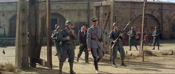 Movie still from “Von Ryan's Express” (1965), directed by Mark Robson – A group of men dressed in military uniforms; Wide shot, Low angle