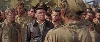 Movie still from “Von Ryan's Express” (1965), directed by Mark Robson – A group of men standing next to each other; Medium shot, Over the shoulder angle