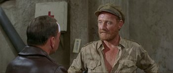 Movie still from “Von Ryan's Express” (1965), directed by Mark Robson – A person wearing a hat; Close Up shot, Over the shoulder angle