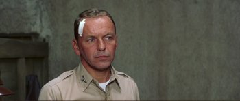 Movie still from “Von Ryan's Express” (1965), directed by Mark Robson – A man with a bandage on his head; Close Up shot, Over the shoulder angle