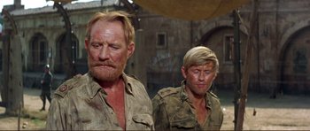 Movie still from “Von Ryan's Express” (1965), directed by Mark Robson – A man and a man in a military uniform; Close Up shot, Low angle