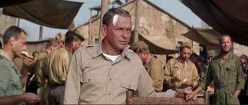 Movie still from “Von Ryan's Express” (1965), directed by Mark Robson – An older man with bandage on his head; Medium shot, Over the shoulder angle