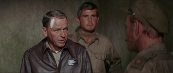 Movie still from “Von Ryan's Express” (1965), directed by Mark Robson – Two men standing next to each other in a room; Close Up shot, Over the shoulder angle