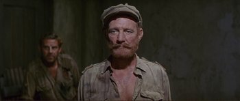 Movie still from “Von Ryan's Express” (1965), directed by Mark Robson – A person wearing a hat and a shirt; Close Up shot, Over the shoulder angle