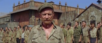 Movie still from “Von Ryan's Express” (1965), directed by Mark Robson – An old man with a red beard wearing a hat; Medium shot, Low angle