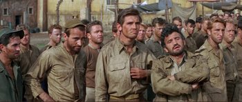 Movie still from “Von Ryan's Express” (1965), directed by Mark Robson – A group of men standing next to each other; Medium shot, Low angle