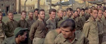 Movie still from “Von Ryan's Express” (1965), directed by Mark Robson – A group of men standing next to each other; Medium shot, High angle