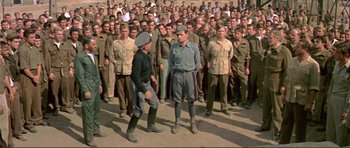Movie still from “Von Ryan's Express” (1965), directed by Mark Robson – A large group of men standing in front of each other; Wide shot, High angle