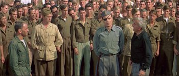 Movie still from “Von Ryan's Express” (1965), directed by Mark Robson – A group of men standing next to each other in uniforms; Medium shot, High angle