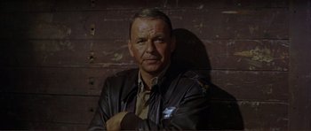 Movie still from “Von Ryan's Express” (1965), directed by Mark Robson – An older man in a leather jacket posing for a picture; Close Up shot, Low angle
