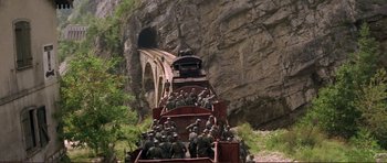 Movie still from “Von Ryan's Express” (1965), directed by Mark Robson – A group of soldiers riding a train down the side of a mountain; Extreme Wide shot, High angle