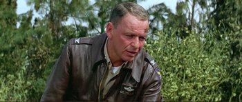 Movie still from “Von Ryan's Express” (1965), directed by Mark Robson – An older man in a leather jacket looking at the camera; Close Up shot, Low angle