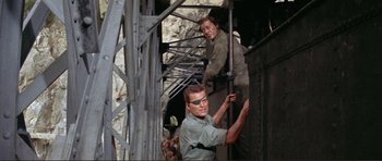 Movie still from “Von Ryan's Express” (1965), directed by Mark Robson – Two men working on a construction project; Medium shot, High angle