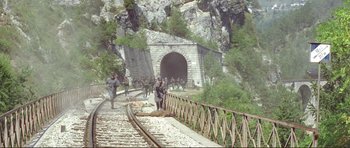 Movie still from “Von Ryan's Express” (1965), directed by Mark Robson – A group of soldiers walking along a train track; Extreme Wide shot, High angle