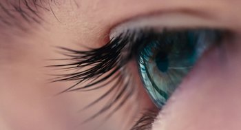 Movie still from “Voyage of Time” (2016), directed by Terrence Malick – A woman's eye with long eyelashes; Extreme Close Up shot, Overhead angle