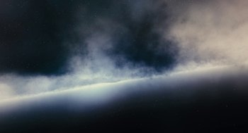 Movie still from “Voyage of Time” (2016), directed by Terrence Malick – A cloud filled sky with the sun shining on it; Extreme Wide shot, Low angle
