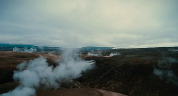 Movie still from “Voyage of Time” (2016), directed by Terrence Malick – Steam rises from the ground in a desert area; Extreme Wide shot, High angle