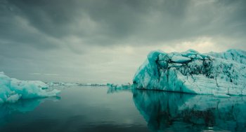 Movie still from “Voyage of Time” (2016), directed by Terrence Malick – A body of water that has a bunch of ice in it; Extreme Wide shot, Low angle